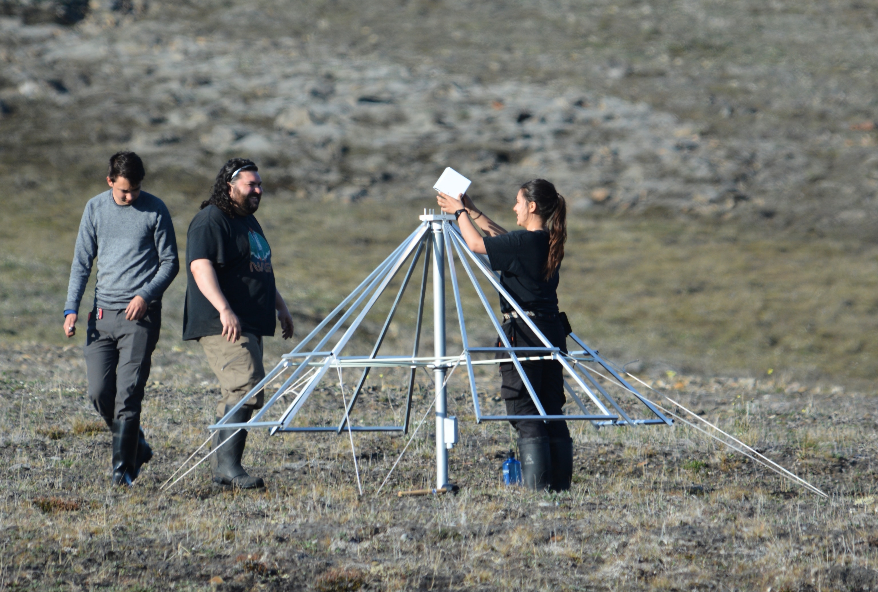 McGill students Tristan Ménard, Larry Herman, and Joëlle Bégin install an ALBATROS radio antenna at the McGill Research Station on Axel Heiberg Island.